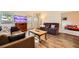 Bright living room with wood-look flooring, comfortable seating, a television, and plenty of natural light at 2611 Laguna Shores Ln, Las Vegas, NV 89121