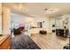 Open-concept living space with modern lighting, fireplace, and wood flooring at 2611 Laguna Shores Ln, Las Vegas, NV 89121
