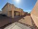 Expansive backyard featuring a covered patio, low maintenance landscaping, and ample space for outdoor activities at 2628 Park Hyatt Ave, North Las Vegas, NV 89081