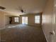 Large bonus room featuring carpet flooring, a ceiling fan, and ample natural light at 2628 Park Hyatt Ave, North Las Vegas, NV 89081