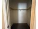 Empty closet interior with neutral walls, wood shelf and rod, and dark flooring, ready for storage at 2628 Park Hyatt Ave, North Las Vegas, NV 89081