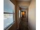 Hallway with natural light coming through the window, leading to other rooms in the house at 2628 Park Hyatt Ave, North Las Vegas, NV 89081
