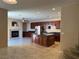 Open kitchen featuring a large island, stainless steel appliances, and dark wood cabinets at 2628 Park Hyatt Ave, North Las Vegas, NV 89081