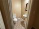 Small powder room featuring toilet and pedestal sink with a frame hanging on the wall at 2628 Park Hyatt Ave, North Las Vegas, NV 89081
