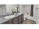 Bathroom featuring double sinks, granite countertops, and a shower-tub combination at 2682 Weathered Copper Ave, North Las Vegas, NV 89086