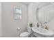 Well-lit half bathroom with a sleek, modern vanity and round mirror at 2682 Weathered Copper Ave, North Las Vegas, NV 89086