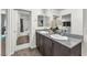 Bathroom with dual sinks, granite counters, and a view of the shower and closet at 2682 Weathered Copper Ave, North Las Vegas, NV 89086