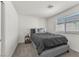 Cozy bedroom with a comfortable bed, soft bedding, and a nightstand with a lamp at 2682 Weathered Copper Ave, North Las Vegas, NV 89086