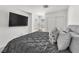 This bedroom features a modern design with a large TV and soft, comfortable bedding at 2682 Weathered Copper Ave, North Las Vegas, NV 89086