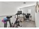 Upstairs bonus room with multiple desks, a Peloton exercise bike, and bright natural light at 2682 Weathered Copper Ave, North Las Vegas, NV 89086