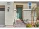 Close-up of home's front door features brick steps, desert landscaping, and a modern door at 2682 Weathered Copper Ave, North Las Vegas, NV 89086