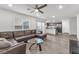Open floor plan featuring living room with view of kitchen, hard surface flooring, and ceiling fan at 2682 Weathered Copper Ave, North Las Vegas, NV 89086