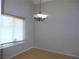 Bright dining area with laminate flooring, large window, and modern chandelier at 2711 Sesame Dr, Las Vegas, NV 89142