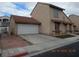 A spacious two-story home showcasing a two-car garage, red tile roof, and a concrete driveway at 2711 Sesame Dr, Las Vegas, NV 89142