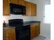 Cozy kitchen featuring wooden cabinets and modern black appliances at 2711 Sesame Dr, Las Vegas, NV 89142