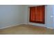A brightly lit living room featuring laminate flooring and a large window with orange curtains at 2711 Sesame Dr, Las Vegas, NV 89142