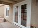 Outdoor patio with white double doors and a small window at 2711 Sesame Dr, Las Vegas, NV 89142