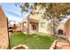 Charming backyard boasts lush artificial turf, covered patio, and inviting space for outdoor relaxation and entertaining at 2752 Drummossie Dr, Henderson, NV 89044