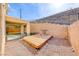 Private backyard featuring a wood deck, rock landscaping, and a covered patio, perfect for outdoor living and entertaining at 2752 Drummossie Dr, Henderson, NV 89044
