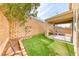 Cozy backyard featuring low-maintenance artificial turf, covered patio, and retaining wall for added privacy at 2752 Drummossie Dr, Henderson, NV 89044