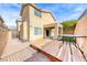 The house shows an inviting backyard features a wood deck, rock landscaping, and covered patio for outdoor enjoyment at 2752 Drummossie Dr, Henderson, NV 89044