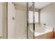 This bathroom has a separate glass shower and a soaking tub with glass block windows for privacy at 2752 Drummossie Dr, Henderson, NV 89044