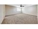Large carpeted bedroom features a ceiling fan and neutral color palette at 2752 Drummossie Dr, Henderson, NV 89044