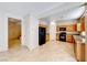 Open kitchen with tile flooring, wooden cabinets, and black appliances at 2752 Drummossie Dr, Henderson, NV 89044