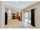 Open kitchen with tile flooring, wooden cabinets, and sliding doors to the backyard at 2752 Drummossie Dr, Henderson, NV 89044