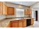 Kitchen featuring wooden cabinets, granite countertops, and a stainless steel sink at 2752 Drummossie Dr, Henderson, NV 89044