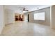 Bright living room featuring tile flooring, natural light, and an open floor plan to the kitchen at 2752 Drummossie Dr, Henderson, NV 89044