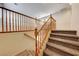 Carpeted staircase with wood railing leads to the second floor of the home at 2752 Drummossie Dr, Henderson, NV 89044