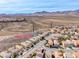 Street view featuring well-maintained homes nestled against a backdrop of mountains and desert landscape at 2752 Drummossie Dr, Henderson, NV 89044