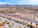 Street view featuring well-maintained homes nestled against a backdrop of mountains and desert landscape at 2752 Drummossie Dr, Henderson, NV 89044