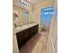 Bathroom featuring granite countertops, dark wood cabinets, modern lighting, and tile flooring at 2790 Chetco River St, Laughlin, NV 89029