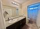 A bathroom with a granite countertop, modern lighting, and an open view to the shower and toilet at 2790 Chetco River St, Laughlin, NV 89029