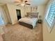 A large bedroom features carpet floors, modern lighting, a large bed and a window shutter at 2790 Chetco River St, Laughlin, NV 89029