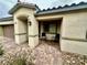 Charming single story home with covered entryway and two chairs on a brick paver landing at 2790 Chetco River St, Laughlin, NV 89029