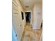 Tile hallway with neutral walls, white doors, and decorative accents at 2790 Chetco River St, Laughlin, NV 89029
