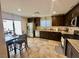 Spacious kitchen with dark cabinets, stainless steel appliances, dining area, and access to the backyard at 2790 Chetco River St, Laughlin, NV 89029