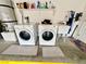 A laundry room with a washer, dryer, sink, and shelving for storage at 2790 Chetco River St, Laughlin, NV 89029