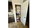 Pantry in the kitchen with shelving full of storage and a 6-panel door at 2790 Chetco River St, Laughlin, NV 89029
