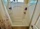 A well-lit shower and tub combination with built-in shelving for toiletries at 2790 Chetco River St, Laughlin, NV 89029