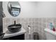 Cozy bathroom with patterned accent wall and vessel sink, perfect for compact spaces and modern aesthetic at 2870 Belcastro St, Las Vegas, NV 89117