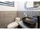 Stylish half-bathroom featuring a unique vessel sink and decorative patterned tile at 2870 Belcastro St, Las Vegas, NV 89117