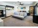 Relaxing bedroom with a large window, neutral colors, and an en-suite bathroom at 2870 Belcastro St, Las Vegas, NV 89117