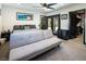 Comfortable bedroom with a gray sofa, black doors, and a view of the yard at 2870 Belcastro St, Las Vegas, NV 89117