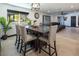 Dining area featuring a dark wood table and four chairs, alongside a window and view to the living room at 2870 Belcastro St, Las Vegas, NV 89117