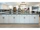 Updated kitchen features white cabinets, stainless steel appliances, and a gorgeous green island at 2870 Belcastro St, Las Vegas, NV 89117