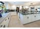 Bright kitchen with a large island, stainless appliances, and white cabinets with black handles at 2870 Belcastro St, Las Vegas, NV 89117